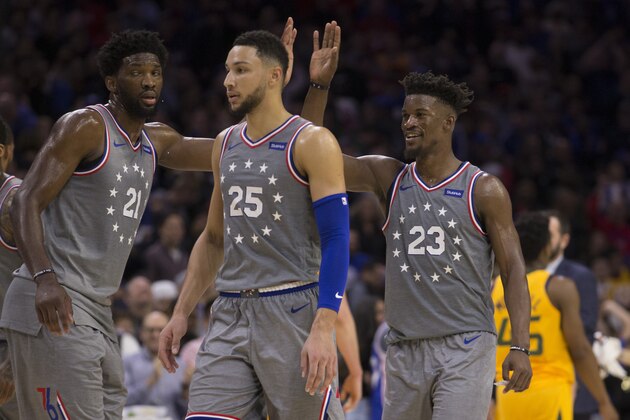 PHILADELPHIA, PA - NOVEMBER 16: Joel Embiid #21, Ben Simmons #25, and Jimmy Butler #23 of the Philadelphia 76ers celebrate against the Utah Jazz during a timeout in the fourth quarter at the Wells Fargo Center on November 16, 2018 in Philadelphia, Pennsylvania. The 76ers defeated the Jazz 113-107. NOTE TO USER: User expressly acknowledges and agrees that, by downloading and or using this photograph, User is consenting to the terms and conditions of the Getty Images License Agreement. (Photo by Mitchell Leff/Getty Images)