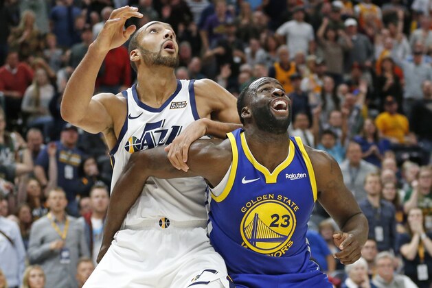 Utah Jazz center Rudy Gobert, left, and Golden State Warriors forward Draymond Green (23) battle for position under the basket in the second half during an NBA basketball game Friday, Oct. 19, 2018, in Salt Lake City. (AP Photo/Rick Bowmer)
