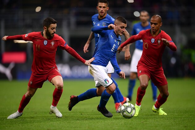 Italy's midfielder Marco Verratti (C) makes his wau through Portugal's midfielder Bernardo Silva (L) and Portugal's midfielder Joao Mario during the UEFA Nations League group 3 football match Italy vs Portugal at the San Siro Stadium in Milan on November 17, 2018. (Photo by Marco BERTORELLO / AFP)        (Photo credit should read MARCO BERTORELLO/AFP/Getty Images)