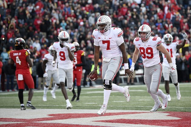 Ohio State quarterback Dwayne Haskins Jr. (7) celebrates his touchdown next to tight end Luke Farrell (89) and wide receiver Binjimen Victor (9) during the overtime of an NCAA football game as Maryland defensive back Darnell Savage Jr. (4) looks on at left, Saturday, Nov. 17, 2018, in College Park, Md. Ohio State won 52-51. (AP Photo/Nick Wass)
