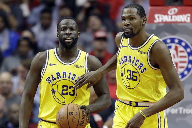 Golden State Warriors' Kevin Durant (35) pats Draymond Green (23) on the chest after a turnover during the second half of an NBA basketball game against the Houston Rockets Thursday, Nov. 15, 2018, in Houston. (AP Photo/David J. Phillip)