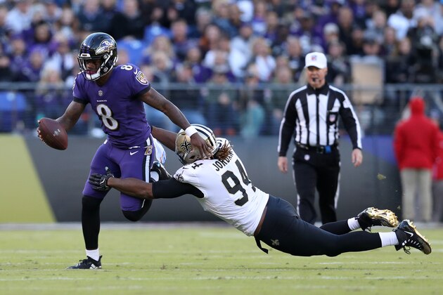 BALTIMORE, MD - OCTOBER 21:  Quarterback Lamar Jackson #8 of the Baltimore Ravens is tackled as he runs with the ball by defensive end Cameron Jordan #94 of the New Orleans Saints in the second quarter at M&T Bank Stadium on October 21, 2018 in Baltimore, Maryland. (Photo by Patrick Smith/Getty Images)