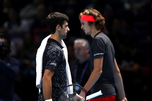 LONDON, ENGLAND - NOVEMBER 18:  Alexander Zverev of Germany and Novak Djokovic of Serbia cross paths after the first set during their singles final during Day Eight of the Nitto ATP Finals at The O2 Arena on November 18, 2018 in London, England.  (Photo by Julian Finney/Getty Images)