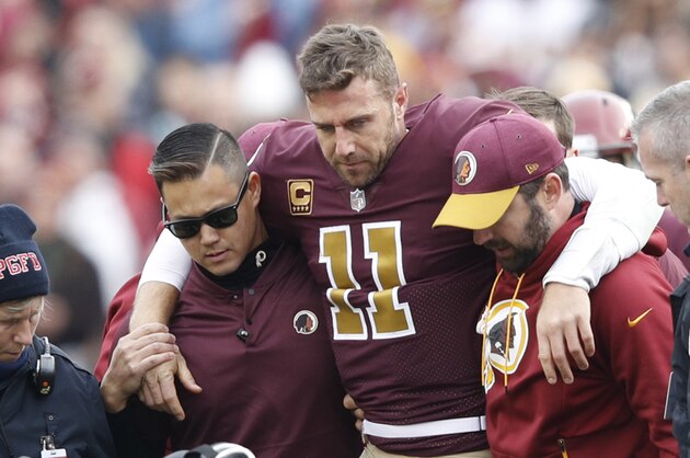 LANDOVER, MD - NOVEMBER 18: Alex Smith #11 of the Washington Redskins is helped off the field after being sacked and injured by Kareem Jackson #25 of the Houston Texans in the third quarter of the game at FedExField on November 18, 2018 in Landover, Maryland. (Photo by Joe Robbins/Getty Images)