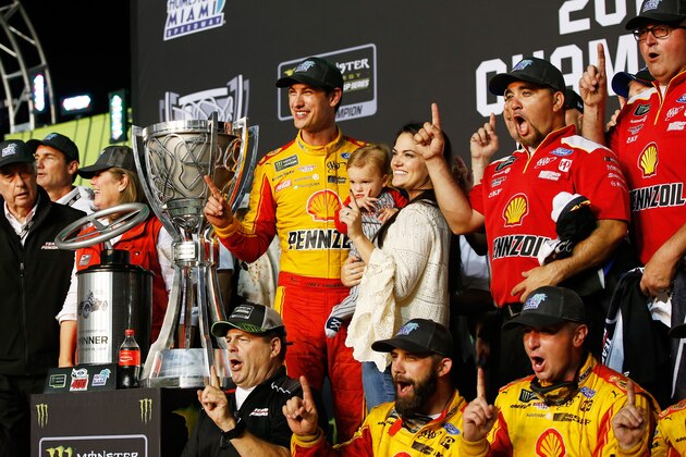 HOMESTEAD, FL - NOVEMBER 18:  Joey Logano, driver of the #22 Shell Pennzoil Ford, celebrates with his wife, Brittany, and son, Hudson, after winning the Monster Energy NASCAR Cup Series Ford EcoBoost 400 at Homestead-Miami Speedway on November 18, 2018 in Homestead, Florida.  (Photo by Chris Trotman/Getty Images)