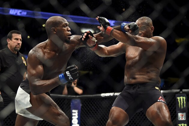 ANAHEIM, CA - JULY 29:  (L-R) Jon Jones punches Daniel Cormier in their UFC light heavyweight championship bout during the UFC 214 event inside the Honda Center on July 29, 2017 in Anaheim, California. (Photo by Jeff Bottari/Zuffa LLC/Zuffa LLC via Getty Images)
