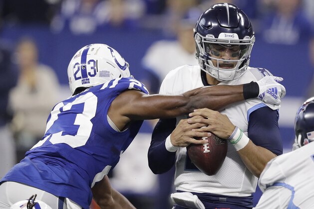 Tennessee Titans quarterback Marcus Mariota is sacked by Indianapolis Colts' Kenny Moore (23) during the first half of an NFL football game, Sunday, Nov. 18, 2018, in Indianapolis. (AP Photo/Darron Cummings)