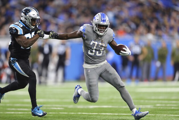 Detroit Lions running back Kerryon Johnson (33) stiff arms Carolina Panthers free safety Mike Adams (29) during the second half of an NFL football game, Sunday, Nov. 18, 2018, in Detroit. (AP Photo/Rey Del Rio)