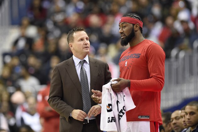 Washington Wizards head coach Scott Brooks, left, talks with Washington Wizards guard John Wall, right, during the second half of an NBA basketball game against the Miami Heat, Thursday, Oct. 18, 2018, in Washington. The Heat won 113-112. (AP Photo/Nick Wass)