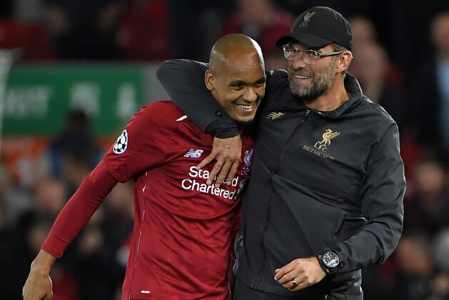Liverpool's Brazilian midfielder Fabinho (L) and Liverpool's German manager Jurgen Klopp react at the final whistle during the UEFA Champions League group C football match between Liverpool and Paris Saint-Germain at Anfield in Liverpool, north west England on September 18, 2018. (Photo by Paul ELLIS / AFP)        (Photo credit should read PAUL ELLIS/AFP/Getty Images)