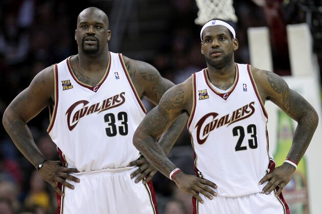 In this Feb. 6, 2010, file photo, Cleveland Cavaliers' Shaquille O'Neal (33) and LeBron James (23) wait for play to resume against the New York Knicks in an NBA basketball game in Cleveland. The Boston Celtics are making progress on a deal that would bring O'Neal to the defending Eastern Conference champions, a person with knowledge of the negotiations told The Associated Press. O'Nel has struggled to find a contract from a team that can guarantee him playing time, enough money and a chance for one more championship. He has all-but ruled out joining James in Miami or a return to Orlando, where he began his career in 1992. (AP Photo/Tony Dejak, File)