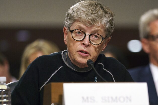 FILE - In this June 5, 2018 file photo, former Michigan State President Lou Anna Simon testifies before a Senate subcommittee in Washington. Simon has been charged with lying to police conducting an investigation of Larry Nassar's sexual abuse. Simon, who stepped down earlier this year over the scandal, was charged Tuesday, Nov. 20, 2018, with two felonies and two misdemeanors. (AP Photo/Carolyn Kaster, File)