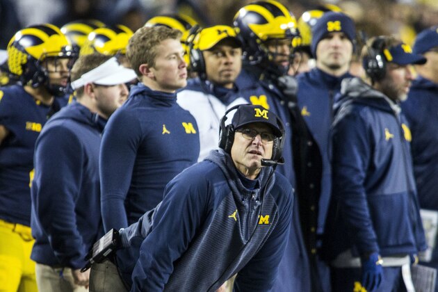 Michigan head coach Jim Harbaugh, center, looks up at the scoreboard from the sidelines in the fourth quarter of an NCAA college football game against Indiana in Ann Arbor, Mich., Saturday, Nov. 17, 2018. Michigan won 31-20. (AP Photo/Tony Ding)