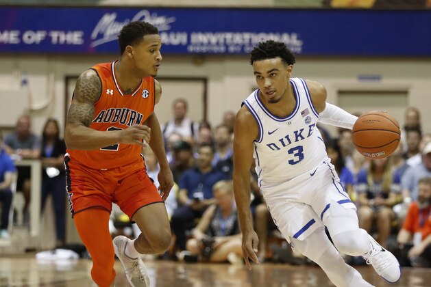 Duke guard Tre Jones (3) tries to dribble around Auburn guard Bryce Brown (2) during the first half of an NCAA college basketball game at the Maui Invitational, Tuesday, Nov. 20, 2018, in Lahaina, Hawaii. (AP Photo/Marco Garcia)
