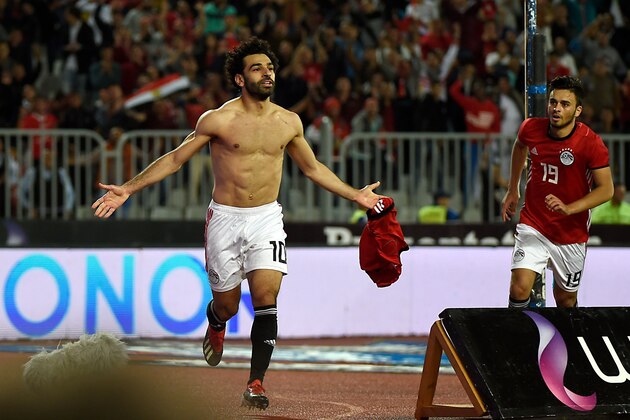 Egypt's forward Mohamed Salah (L) celebrates after scoring a goal during the Africa Cup of Nations qualifier football match Egypt vs Tunisia at the Borg El Arab Stadium, near Alexandria, on November 16, 2018. (Photo by KHALED DESOUKI / AFP)        (Photo credit should read KHALED DESOUKI/AFP/Getty Images)