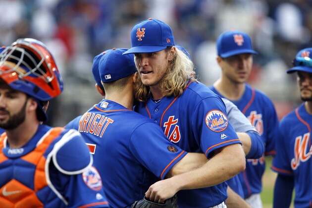 New York Mets' Noah Syndergaard is congratulated by teammate David Wright after pitching a complete-game shutout during a baseball game against the Miami Marlins, Sunday, Sept. 30, 2018, in New York. (AP Photo/Jason DeCrow)