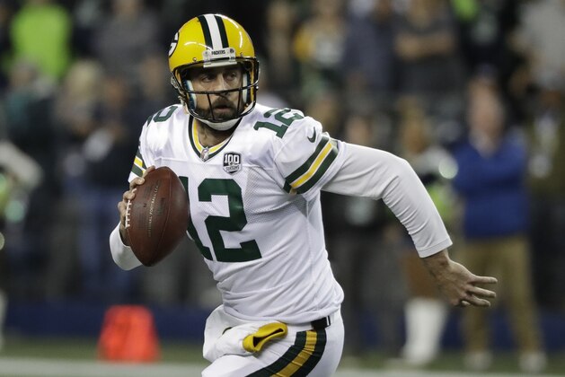 Green Bay Packers quarterback Aaron Rodgers looks to pass against the Seattle Seahawks during the first half of an NFL football game, Thursday, Nov. 15, 2018, in Seattle. (AP Photo/Elaine Thompson)