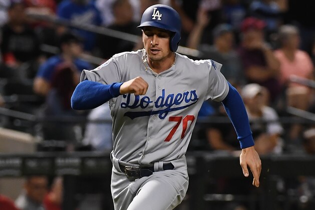 PHOENIX, AZ - SEPTEMBER 24:  Tim Locastro #70 of the Los Angeles Dodgers scores on a single by teammate Max Muncy #13 during the seventh inning against the Arizona Diamondbacks at Chase Field on September 24, 2018 in Phoenix, Arizona.  (Photo by Norm Hall/Getty Images)