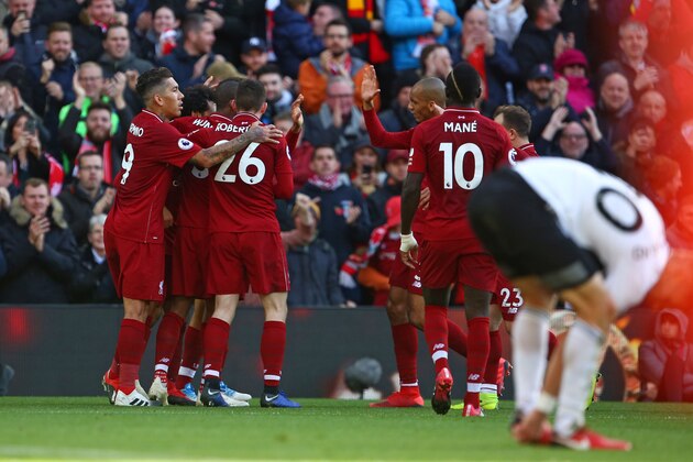Liverpool's Egyptian midfielder Mohamed Salah celebrates with teammates after scoring the opening goal of the English Premier League football match between Liverpool and Fulham at Anfield in Liverpool, north west England on November 11, 2018. (Photo by Geoff CADDICK / AFP) / RESTRICTED TO EDITORIAL USE. No use with unauthorized audio, video, data, fixture lists, club/league logos or 'live' services. Online in-match use limited to 120 images. An additional 40 images may be used in extra time. No video emulation. Social media in-match use limited to 120 images. An additional 40 images may be used in extra time. No use in betting publications, games or single club/league/player publications. /         (Photo credit should read GEOFF CADDICK/AFP/Getty Images)