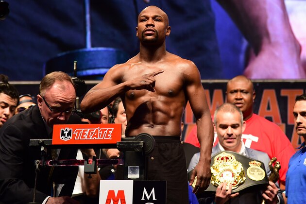 Floyd Mayweather gestures while standing on the scales during the weigh-in on May 1, 2015 in Las Vegas, Nevada one day before his 'Fight of the Century' against Manny Pacquiao on May 2 at the MGM Grand Garden Arena here. AFP PHOTO / FREDERIC J. BROWN        (Photo credit should read FREDERIC J. BROWN/AFP/Getty Images)