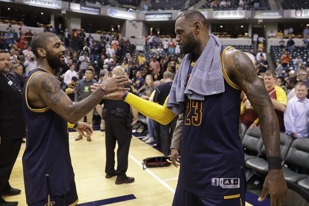 Cleveland Cavaliers' LeBron James, right, and Kyrie Irving celebrate after Cleveland defeated the Indiana Pacers 106-102 to win Game 4 of a first-round NBA basketball playoff series, Sunday, April 23, 2017, in Indianapolis. Cleveland won the series 4-0. (AP Photo/Darron Cummings)