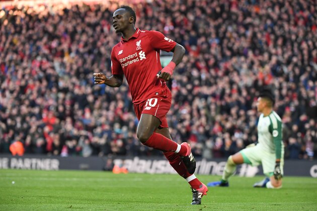 Liverpool's Senegalese striker Sadio Mane celebates scoring their fourth goal during the English Premier League football match between Liverpool and Cardiff City at Anfield in Liverpool, north west England on October 27, 2018. (Photo by Paul ELLIS / AFP) / RESTRICTED TO EDITORIAL USE. No use with unauthorized audio, video, data, fixture lists, club/league logos or 'live' services. Online in-match use limited to 120 images. An additional 40 images may be used in extra time. No video emulation. Social media in-match use limited to 120 images. An additional 40 images may be used in extra time. No use in betting publications, games or single club/league/player publications. / (Photo credit should read PAUL ELLIS/AFP/Getty Images) Liverpool's Senegalese striker Sadio Mane celebates scoring their fourth goal during the English Premier League football match between Liverpool and Cardiff City at Anfield in Liverpool, north west England on October 27, 2018. (Photo by Paul ELLIS / AFP) / RESTRICTED TO EDITORIAL USE. No use with unauthorized audio, video, data, fixture lists, club/league logos or 'live' services. Online in-match use limited to 120 images. An additional 40 images may be used in extra time. No video emulation. Social media in-match use limited to 120 images. An additional 40 images may be used in extra time. No use in betting publications, games or single club/league/player publications. / (Photo credit should read PAUL ELLIS/AFP/Getty Images)