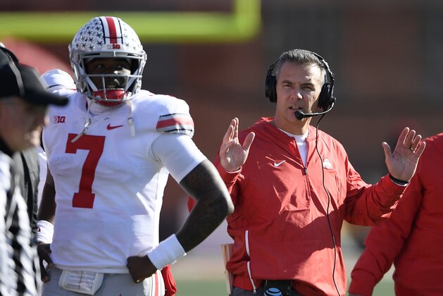 Ohio State head coach Urban Meyer gestures next to Dwayne Haskins Jr. (7) during the first half of an NCAA football game against Maryland, Saturday, Nov. 17, 2018, in College Park, Md. (AP Photo/Nick Wass)