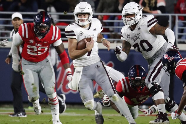 Mississippi State quarterback Nick Fitzgerald (7) runs for short yards against Mississippi during the first half of an NCAA college football game in Oxford, Miss., Thursday, Nov. 22, 2018. (AP Photo/Rogelio V. Solis)