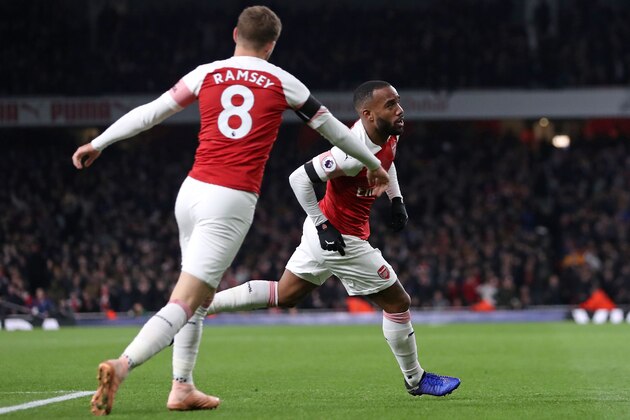 Arsenal's French striker Alexandre Lacazette celebrates with Arsenal's Welsh midfielder Aaron Ramsey (L) after scoring his team's first goal during the English Premier League football match between Arsenal and Liverpool at the Emirates Stadium in London on November 3, 2018. - The game finished 1-1. (Photo by Daniel LEAL-OLIVAS / AFP) / RESTRICTED TO EDITORIAL USE. No use with unauthorized audio, video, data, fixture lists, club/league logos or 'live' services. Online in-match use limited to 120 images. An additional 40 images may be used in extra time. No video emulation. Social media in-match use limited to 120 images. An additional 40 images may be used in extra time. No use in betting publications, games or single club/league/player publications. /         (Photo credit should read DANIEL LEAL-OLIVAS/AFP/Getty Images)