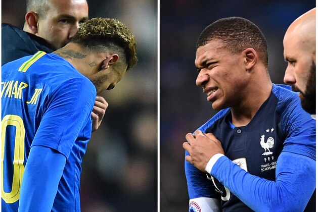 A combination made on November 21, 2018 shows a picture showing Brazil's striker Neymar (L) leaving the pitch injured, on November 20, 2018 in Milton and France's forward Kylian Mbappe holding his shoulder in pain after getting injured on November 20, 2018 in Saint-Denis. - Neymar and Mbappe could be an injury doubt for Paris Saint-Germain's Champions League clash with Liverpool next week after they both left the pitch injured during their respective international friendly matches on November 20, 2018. (Photo by Glyn KIRK and Anne-Christine POUJOULAT / AFP)        (Photo credit should read GLYN KIRK,ANNE-CHRISTINE POUJOULAT/AFP/Getty Images)