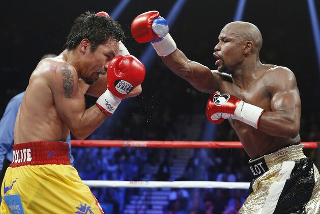 Floyd Mayweather Jr., right, throws a right against Manny Pacquiao, from the Philippines, during their welterweight title fight on Saturday, May 2, 2015 in Las Vegas. (AP Photo/John Locher)