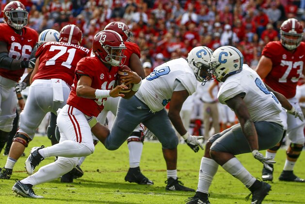 Alabama quarterback Tua Tagovailoa (13) carries the ball as he tries to get around Citadel linebacker Willie Eubanks III (9) during the second half of an NCAA college football game, Saturday, Nov. 17, 2018, in Tuscaloosa, Ala. (AP Photo/Butch Dill)