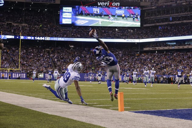 New York Giants wide receiver Odell Beckham (13) makes a one-handed catch for a touchdown against Dallas Cowboys cornerback Brandon Carr (39) in the second quarter of an NFL football game, Sunday, Nov. 23, 2014, in East Rutherford, N.J. (AP Photo/Julio Cortez)
