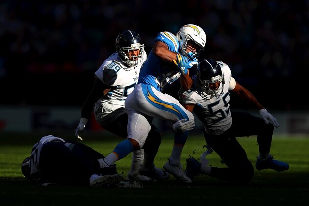 LONDON, ENGLAND - OCTOBER 21:  Austin Ekeler of Los Angeles Chargers is brought down by Jayon Brown of Tennessee Titans  during the NFL International Series match between Tennessee Titans and Los Angeles Chargers at Wembley Stadium on October 21, 2018 in London, England.  (Photo by Naomi Baker/Getty Images)