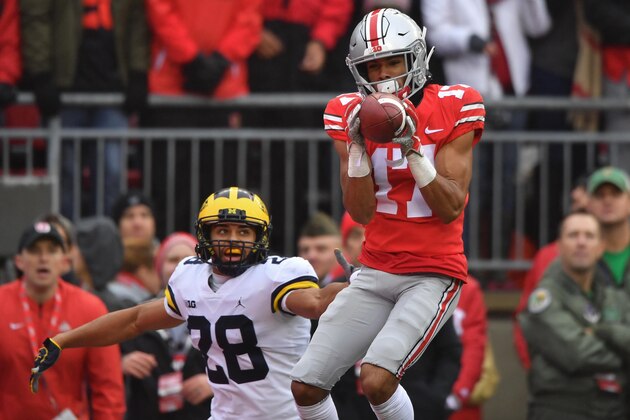 COLUMBUS, OH - NOVEMBER 24:  Chris Olave #17 of the Ohio State Buckeyes catches a 24-yard touchdown pass in the second quarter in front of Brandon Watson #28 of the Michigan Wolverines at Ohio Stadium on November 24, 2018 in Columbus, Ohio.  (Photo by Jamie Sabau/Getty Images)