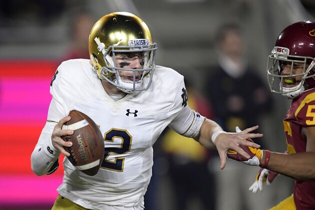 Notre Dame quarterback Ian Book, left, avoids Southern California linebacker Jordan Iosefa during the first half of an NCAA college football game Saturday, Nov. 24, 2018, in Los Angeles. (AP Photo/Mark J. Terrill)