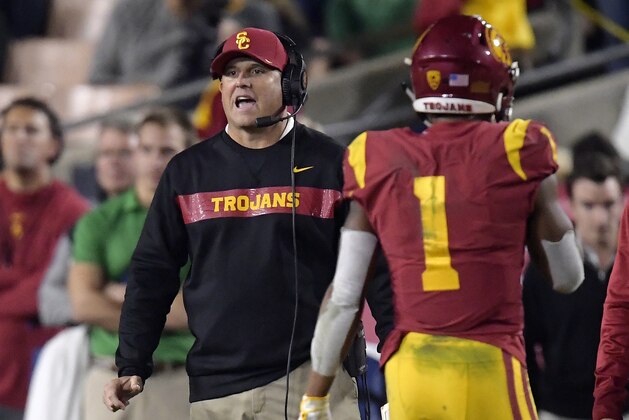 Southern California coach Clay Helton, left, yells to his team as Southern California wide receiver Velus Jones Jr. walks off the field during the second half of an NCAA college football game against Notre Dame on Saturday, Nov. 24, 2018, in Los Angeles. Notre Dame won 24-17. (AP Photo/Mark J. Terrill) Southern California coach Clay Helton, left, yells to his team as Southern California wide receiver Velus Jones Jr. walks off the field during the second half of an NCAA college football game against Notre Dame on Saturday, Nov. 24, 2018, in Los Angeles. Notre Dame won 24-17. (AP Photo/Mark J. Terrill)