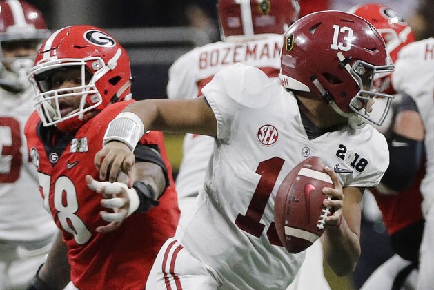 Alabama's Tua Tagovailoa scrambles from Georgia's Trenton Thompson during the second half of the NCAA college football playoff championship game Monday, Jan. 8, 2018, in Atlanta. (AP Photo/David J. Phillip)