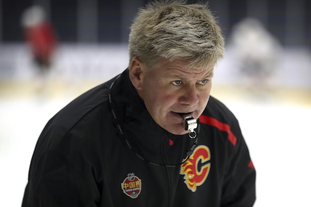 Calgary Flames head coach Bill Peters watches his team practice in Beijing, China, Monday, Sept. 17, 2018. The Flames faced off against the Boston Bruins in southern Chinese city of Shenzhen on Saturday and will play the Bruins again in Beijing on Wednesday in the 2018 NHL China Games. (AP Photo/Mark Schiefelbein)