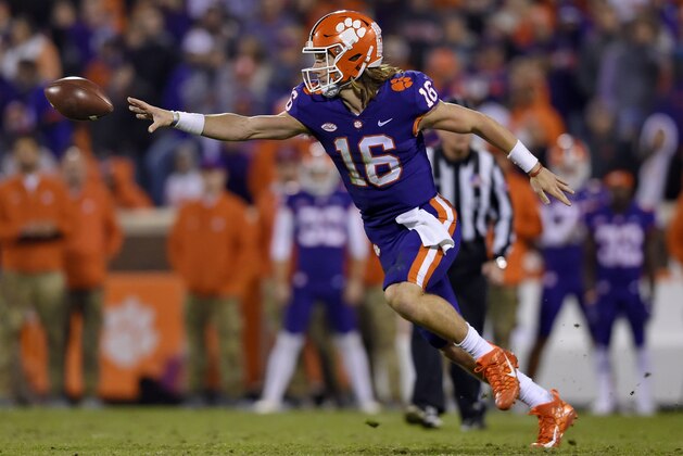 Clemson quarterback Trevor Lawrence tosses the ball to Travis Etienne during the second half of an NCAA college football game against Duke on Saturday, Nov. 17, 2018, in Clemson, S.C. (AP Photo/Richard Shiro)