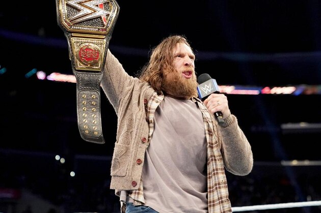 Daniel Bryan posing with the WWE title on SmackDown