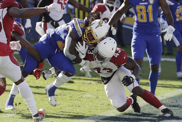Los Angeles Chargers running back Melvin Gordon, left, runs into the end zone for a touchdown as Arizona Cardinals outside linebacker Haason Reddick, right, attempts a tackle during the first half of an NFL football game Sunday, Nov. 25, 2018, in Carson, Calif. (AP Photo/Jae C. Hong )