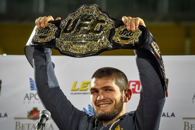 UFC lightweight champion Khabib Nurmagomedov of Russia raises his champions belt upon the arrival in Makhachkala on October 8, 2018. - Nurmagomedov defeated Conor McGregor of Ireland in their UFC lightweight championship bout by way of submission during the UFC 229 event inside T-Mobile Arena on October 6, 2018 in Las Vegas, Nevada. (Photo by Vasily MAXIMOV / AFP)        (Photo credit should read VASILY MAXIMOV/AFP/Getty Images)
