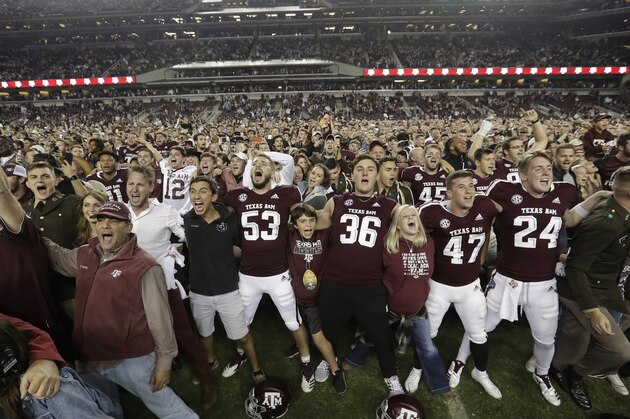 Fans and students join Texas A&M football players on the field after an NCAA college football game against LSU Saturday, Nov. 24, 2018, in College Station, Texas. Texas A&M won 74-72 in seven overtimes.(AP Photo/David J. Phillip)