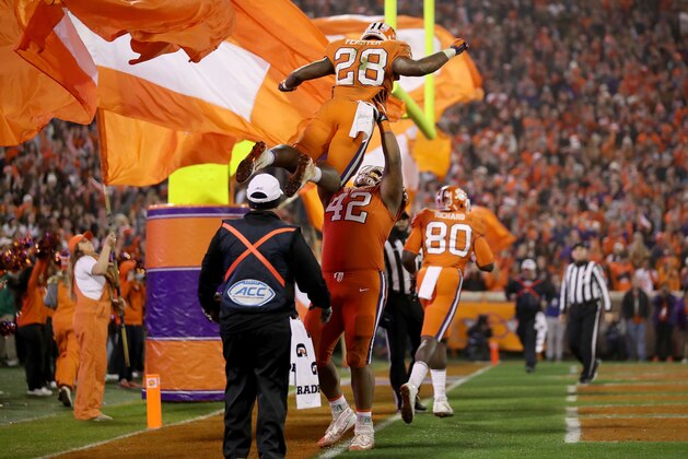 CLEMSON, SC - NOVEMBER 24:  Christian Wilkins #42 picks up teammate Tavien Feaster #28 of the Clemson Tigers after a touchdown against the South Carolina Gamecocks during their game at Clemson Memorial Stadium on November 24, 2018 in Clemson, South Carolina.  (Photo by Streeter Lecka/Getty Images)