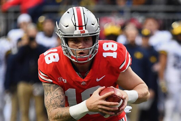 COLUMBUS, OH - NOVEMBER 24:  Quarterback Tate Martell #18 of the Ohio State Buckeyes runs against the Michigan Wolverines at Ohio Stadium on November 24, 2018 in Columbus, Ohio. Ohio State defeated Michigan 62-39.  (Photo by Jamie Sabau/Getty Images)