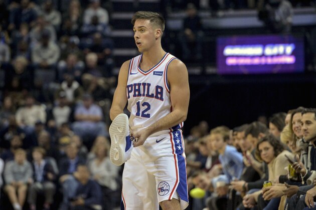Philadelphia 76ers guard T.J. McConnell (12) holds his shoe after losing it during gameplay in the first half of an NBA basketball game against the Memphis Grizzlies Saturday, Nov. 10, 2018, in Memphis, Tenn. (AP Photo/Brandon Dill)