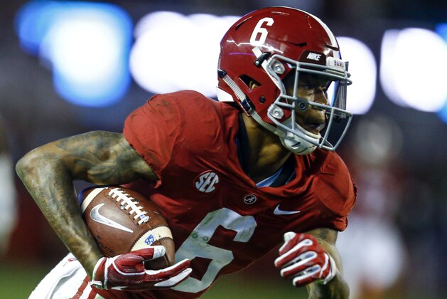 Alabama wide receiver DeVonta Smith (6) carries the ball in for a touchdown during the second half of an NCAA college football game against Auburn, Saturday, Nov. 24, 2018, in Tuscaloosa, Ala. (AP Photo/Butch Dill)