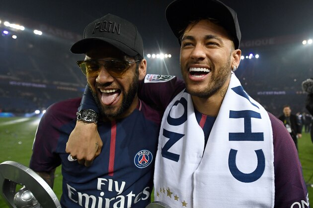 Paris Saint-Germain's Brazilian defender Dani Alves (L) and Paris Saint-Germain's Brazilian forward Neymar joke after winning the French L1 title at the end of the French L1 football match Paris Saint-Germain (PSG) vs Rennes on May 12, 2018 at the Parc des Princes stadium in Paris. (Photo by FRANCK FIFE / AFP)        (Photo credit should read FRANCK FIFE/AFP/Getty Images)