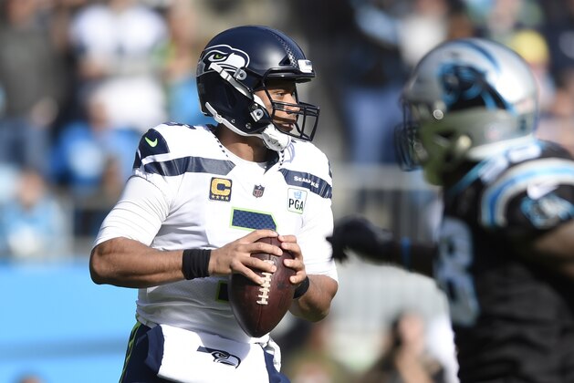 Seattle Seahawks' Russell Wilson (3) looks to pass against the Carolina Panthers during the first half of an NFL football game in Charlotte, N.C., Sunday, Nov. 25, 2018. (AP Photo/Mike McCarn)